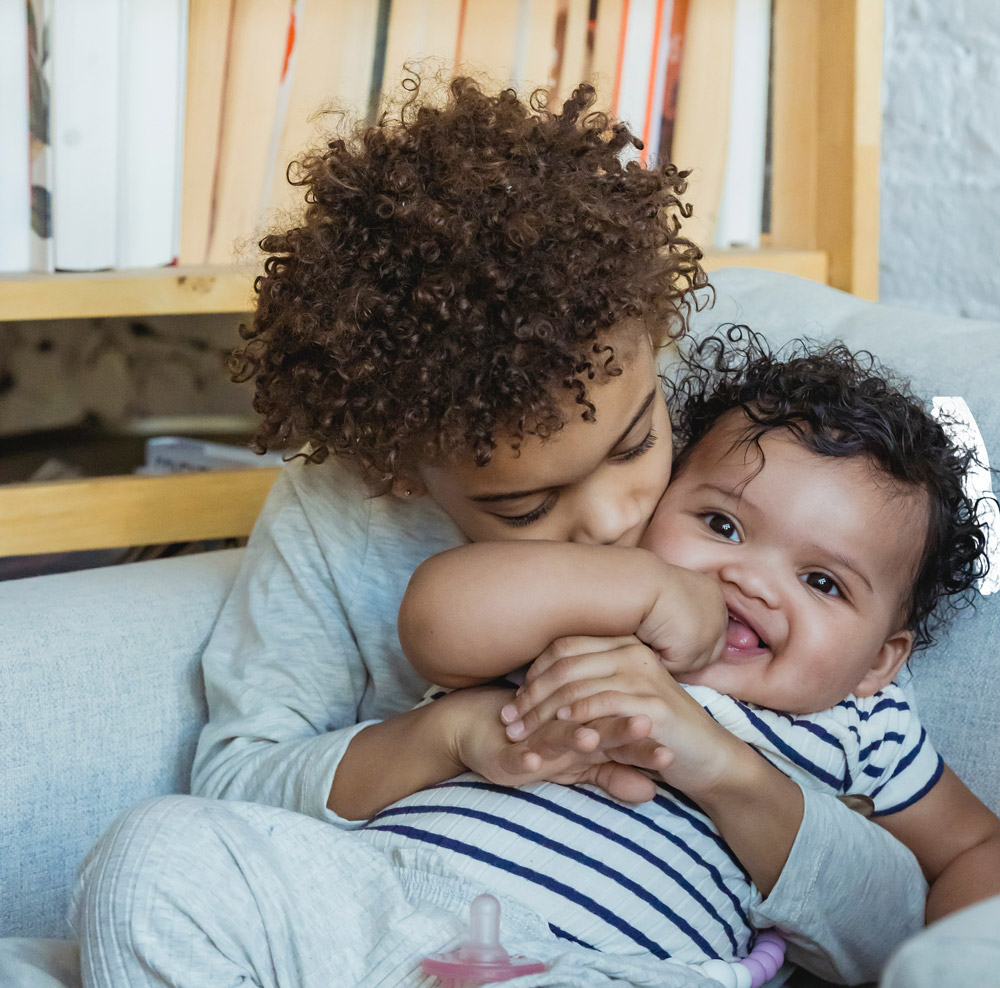 2 Young Siblings Hugging