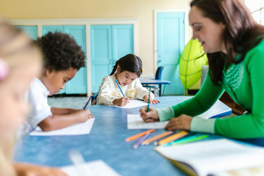 Children working on homework with a child care provider